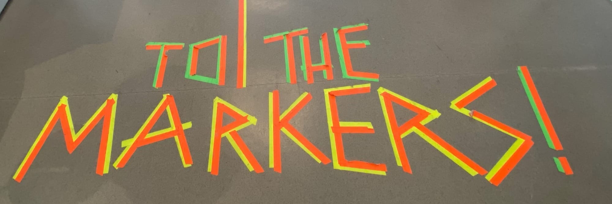 poster with to the markers taped on a floor